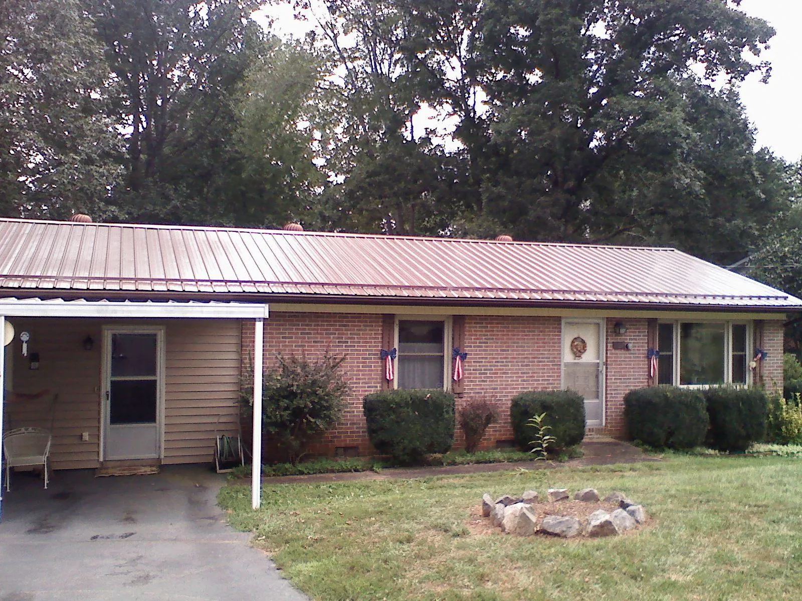 Bronze metal roof and carport on a brick ranch home — Roof Repair work by our crew in Copenhagen