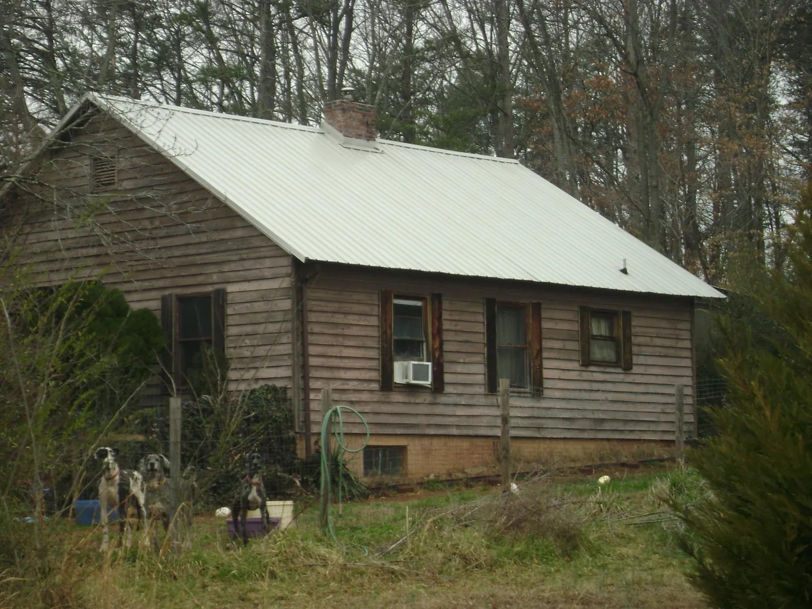 White metal roof on an old wood sided farmhouse, from a Asphalt Shingle Roof Repair job in Copenhagen
